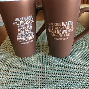 Two tall ceramic cups or mugs from Water for Life